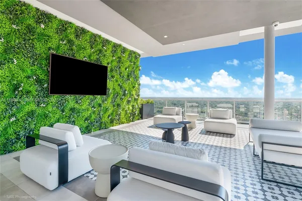 a view of a patio with couches table and chairs with potted plants