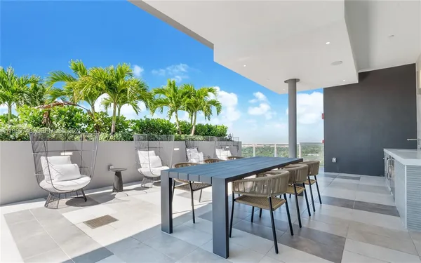 a view of a patio with a table and chairs
