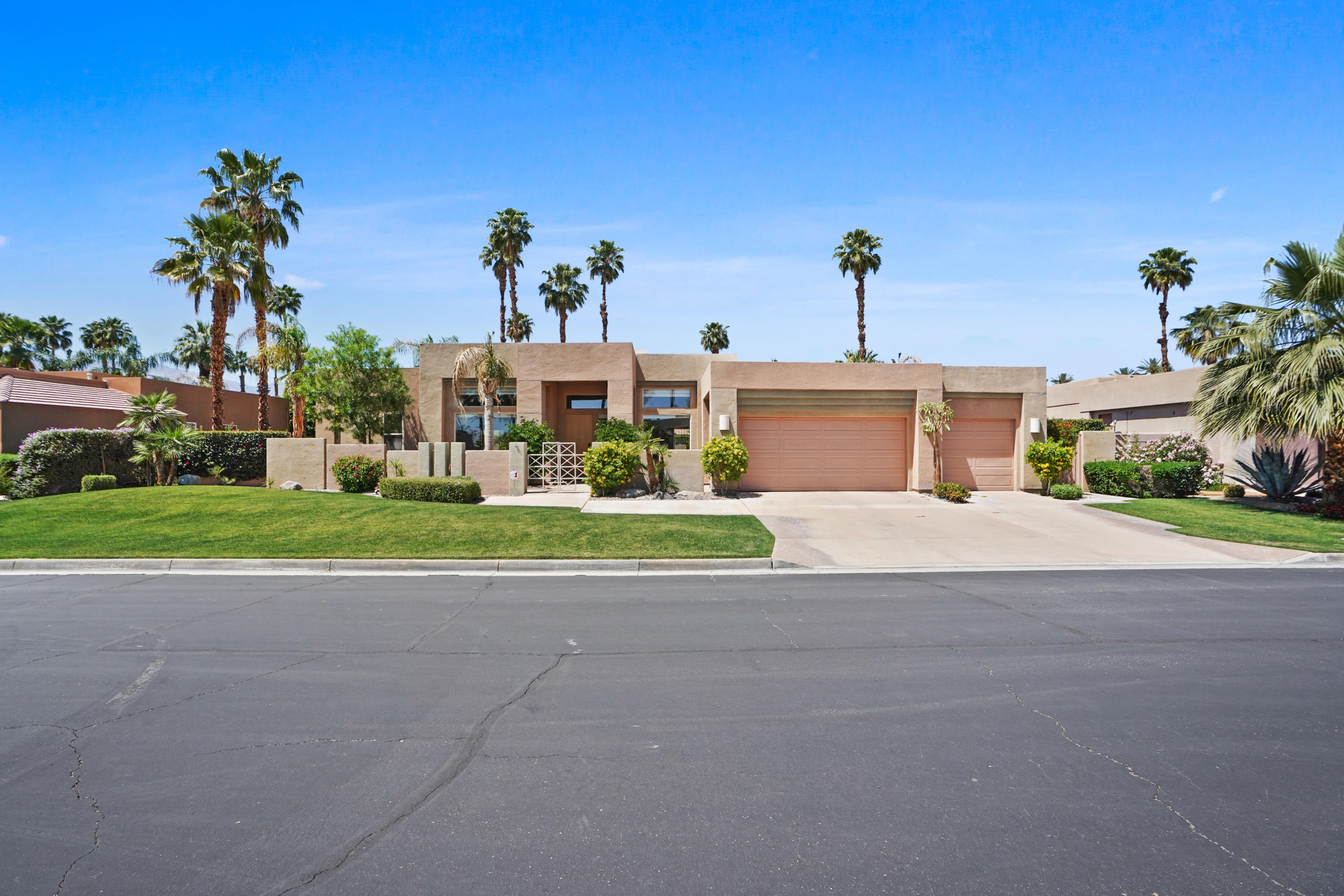 3 Silver Circle Rancho Mirage, CA 92270 - Photo 2 of 34 a front view of a house with a yard and potted plants