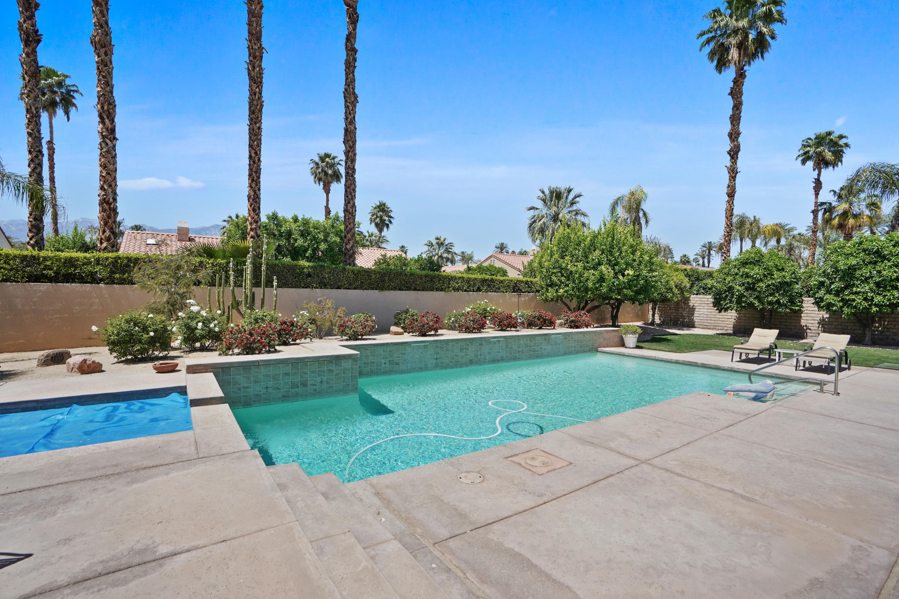 3 Silver Circle Rancho Mirage, CA 92270 - Photo 24 of 34 a view of a terrace with a bench and lake view