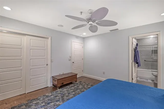 a bedroom with a bed and a ceiling fan