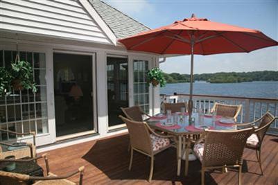 429 Lakeside Drive West Centerville, MA 02632 - Photo 15 of 21 a view of a patio with a table chairs and a umbrella