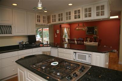 429 Lakeside Drive West Centerville, MA 02632 - Photo 4 of 21 a kitchen with stainless steel appliances granite countertop a sink stove and cabinets