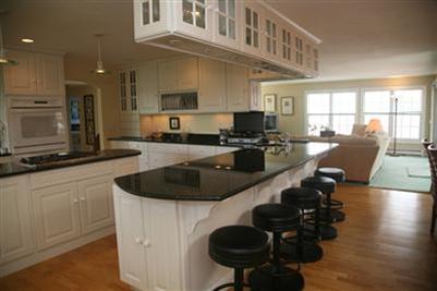 429 Lakeside Drive West Centerville, MA 02632 - Photo 8 of 21 a kitchen with a sink a stove and chairs