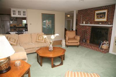 429 Lakeside Drive West Centerville, MA 02632 - Photo 9 of 21 a living room with furniture a flat screen tv and a fireplace