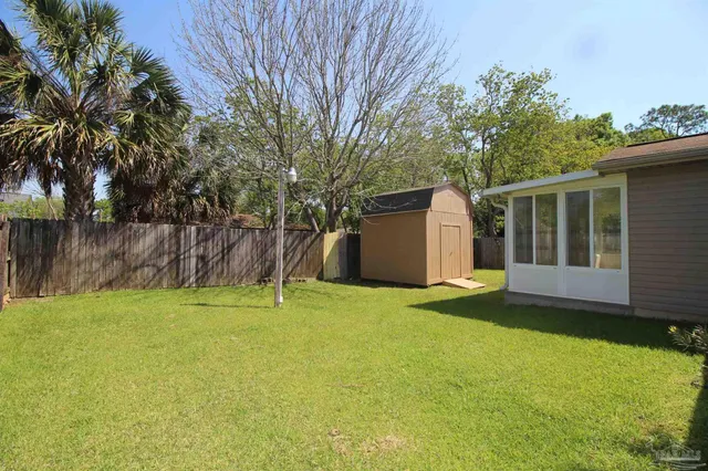 a backyard of a house with table and chairs