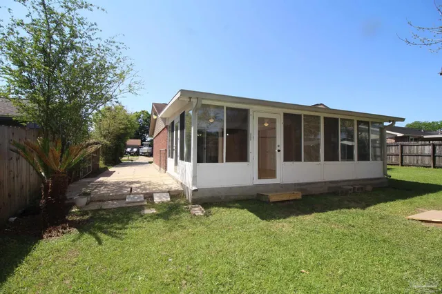 a view of house with backyard