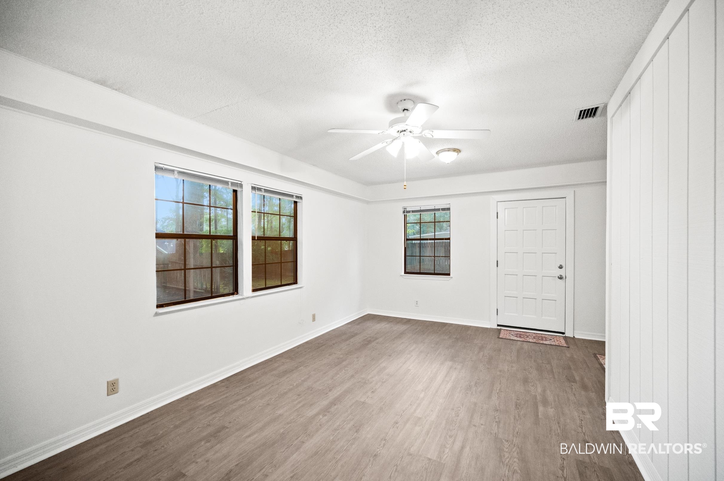 128 Dunbar Loop Daphne, AL 36526 - Photo 25 of 39 Empty room with ceiling fan, hardwood / wood-style flooring, and a textured ceiling