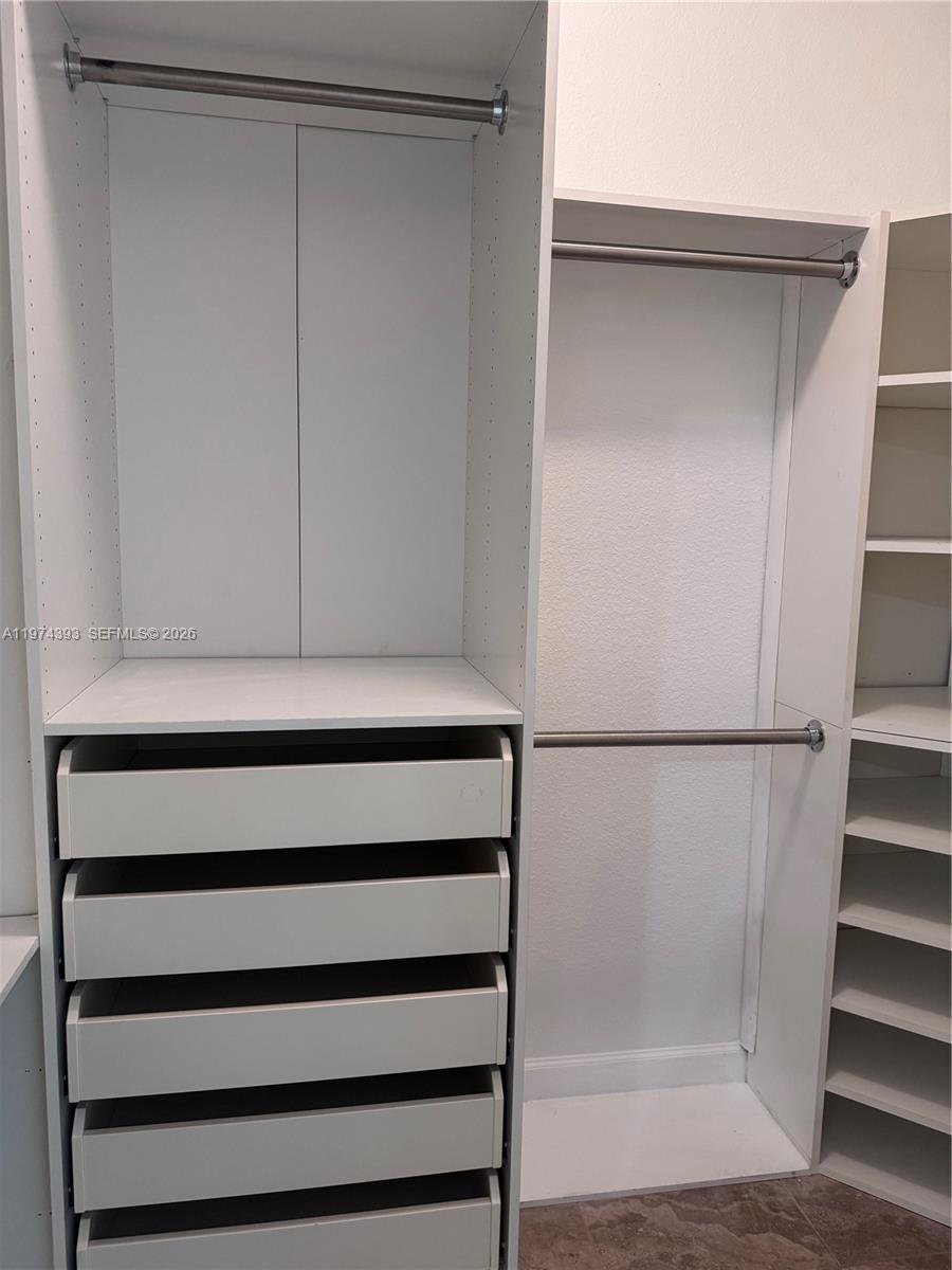 8500 Southwest 150th Avenue, Unit 3 Miami, FL 33193 - Photo 11 of 22 a view of walk in closet with empty racks