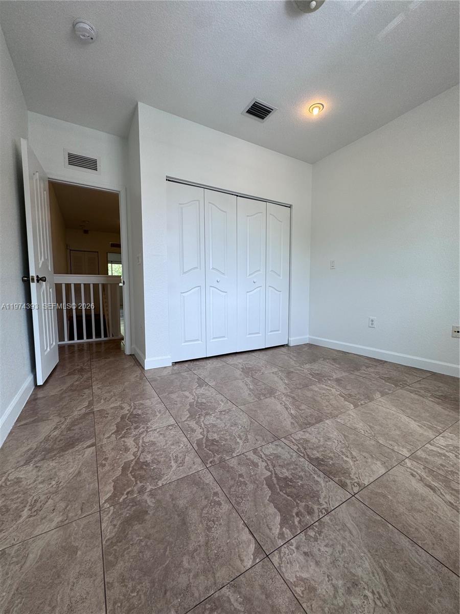 8500 Southwest 150th Avenue, Unit 3 Miami, FL 33193 - Photo 14 of 22 a view of an empty room with glass door