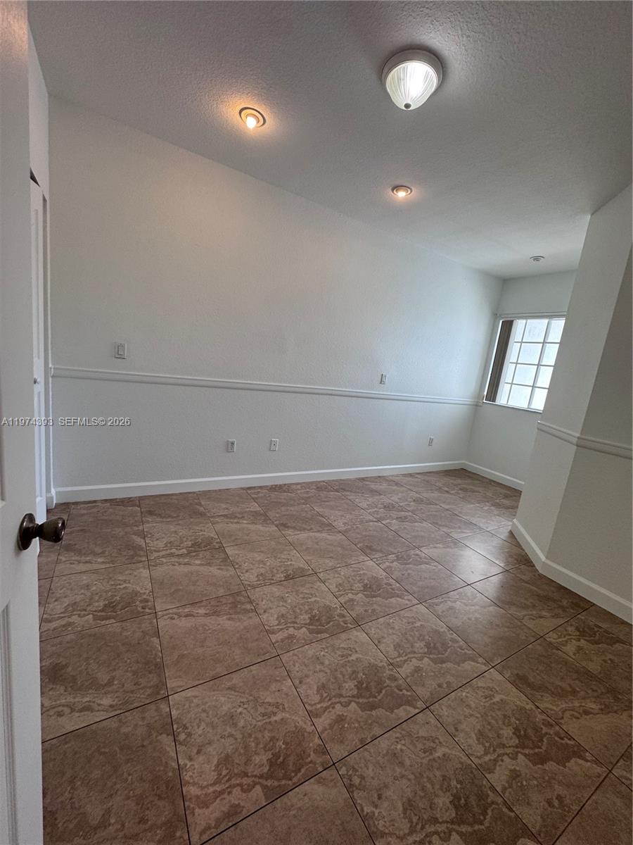 8500 Southwest 150th Avenue, Unit 3 Miami, FL 33193 - Photo 16 of 22 an empty room with a empty space and windows