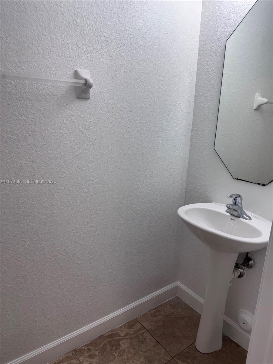 8500 Southwest 150th Avenue, Unit 3 Miami, FL 33193 - Photo 17 of 22 a bathroom with a sink and mirror