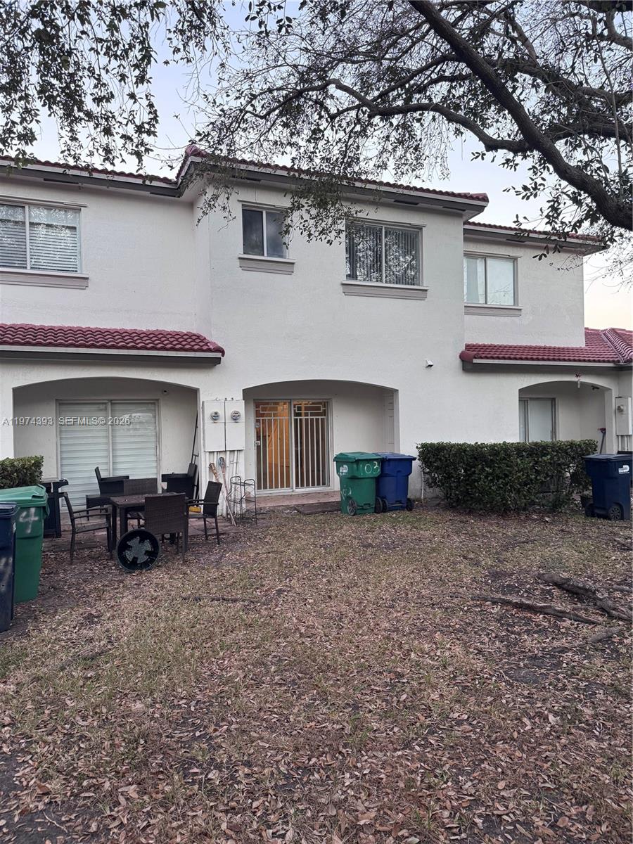 8500 Southwest 150th Avenue, Unit 3 Miami, FL 33193 - Photo 19 of 22 a front view of a house with table and chairs