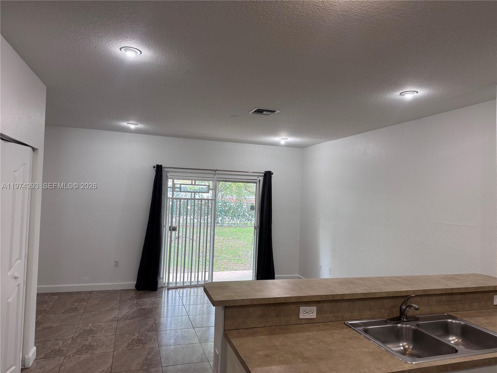 8500 Southwest 150th Avenue, Unit 3 Miami, FL 33193 - Photo 7 of 22 a view of an empty room and window