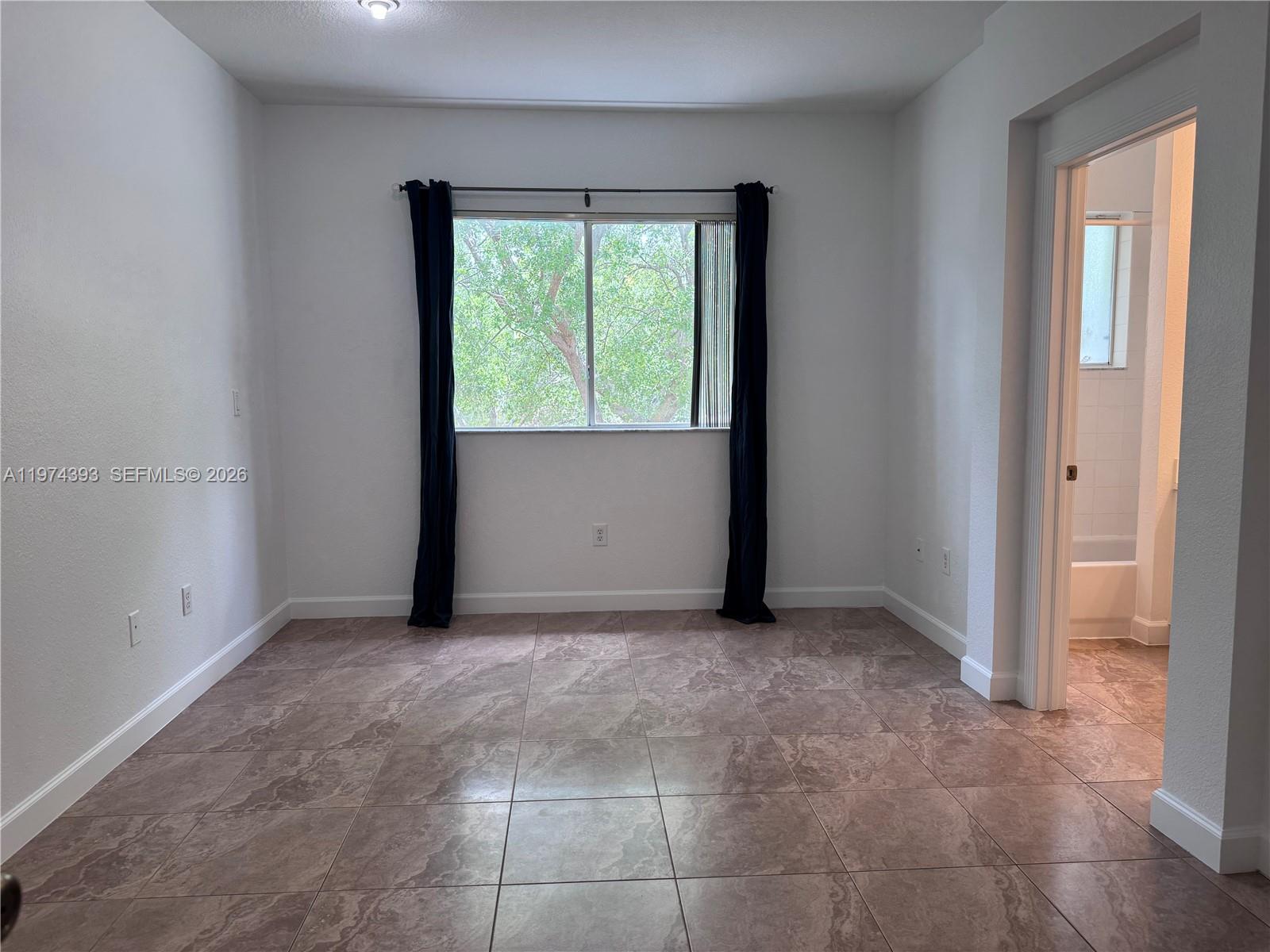 8500 Southwest 150th Avenue, Unit 3 Miami, FL 33193 - Photo 10 of 22 an empty room with windows and closet