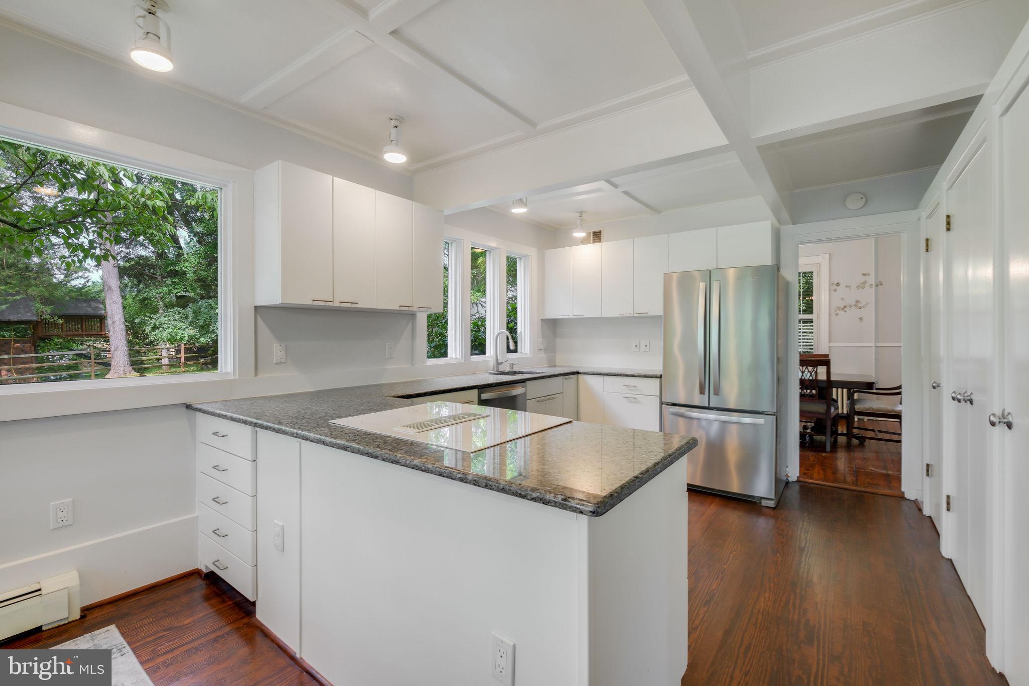 6220 Mazwood Road Rockville, MD 20852 - Photo 12 of 47 a kitchen with stainless steel appliances granite countertop a sink a refrigerator and a stove top oven