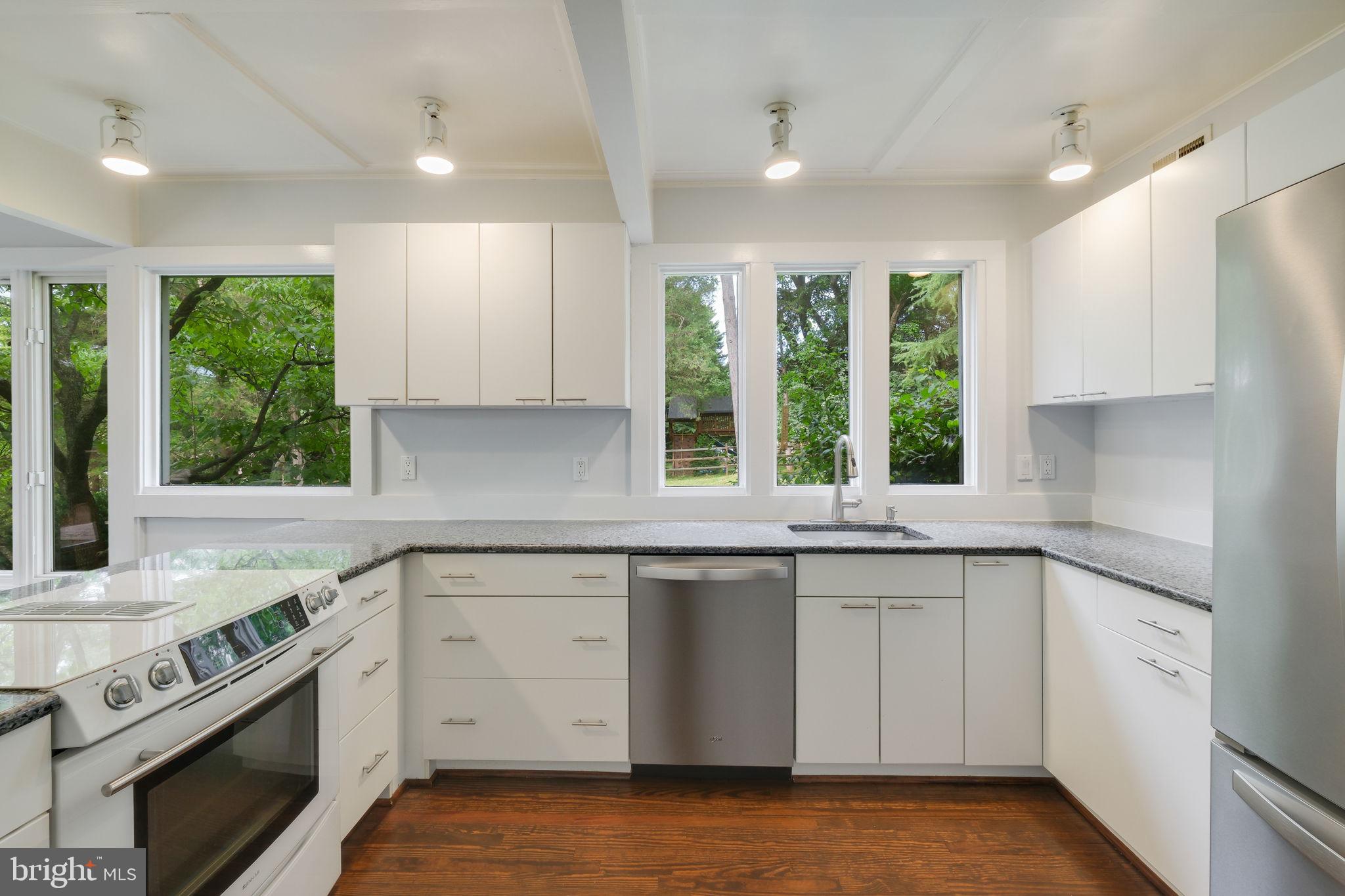 6220 Mazwood Road Rockville, MD 20852 - Photo 13 of 47 a kitchen with a sink stove and cabinets
