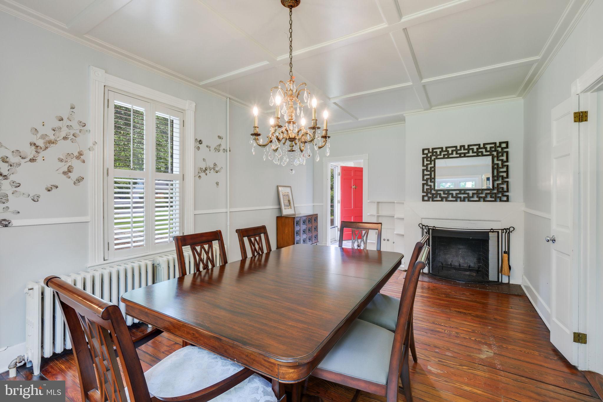 6220 Mazwood Road Rockville, MD 20852 - Photo 17 of 47 a dining room with furniture a chandelier and wooden floor
