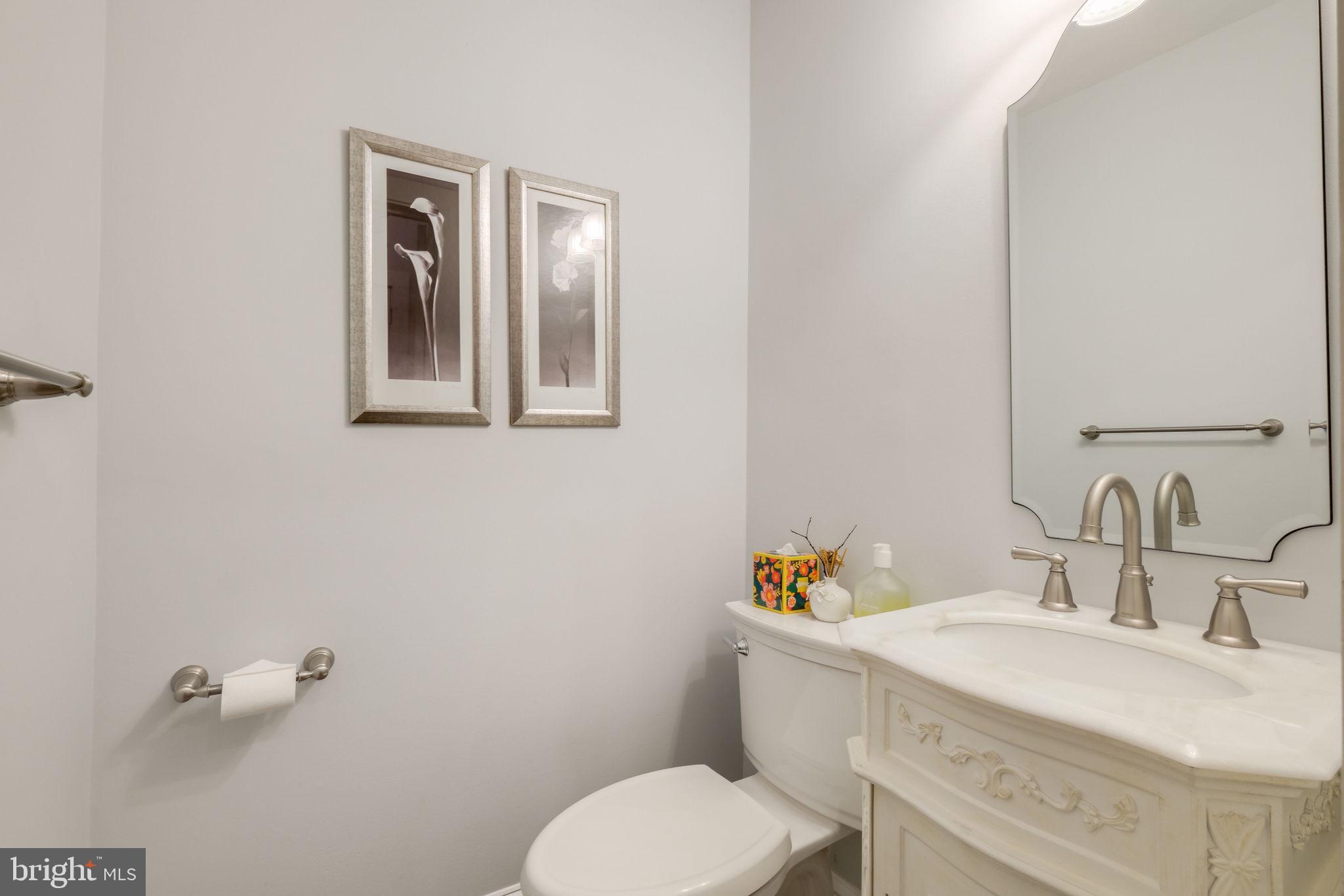 6220 Mazwood Road Rockville, MD 20852 - Photo 18 of 47 a bathroom with a sink mirror and toilet
