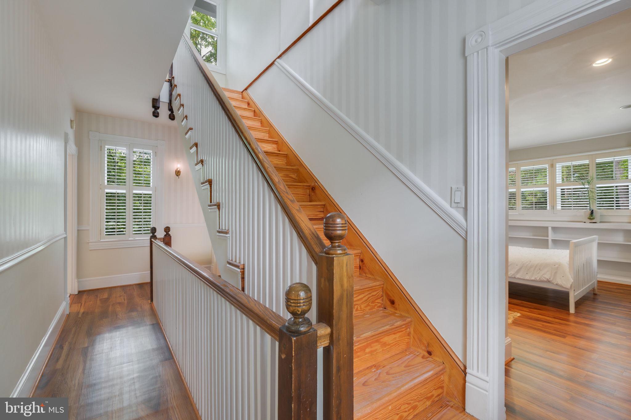6220 Mazwood Road Rockville, MD 20852 - Photo 19 of 47 a view of a hallway with wooden floor and stairs