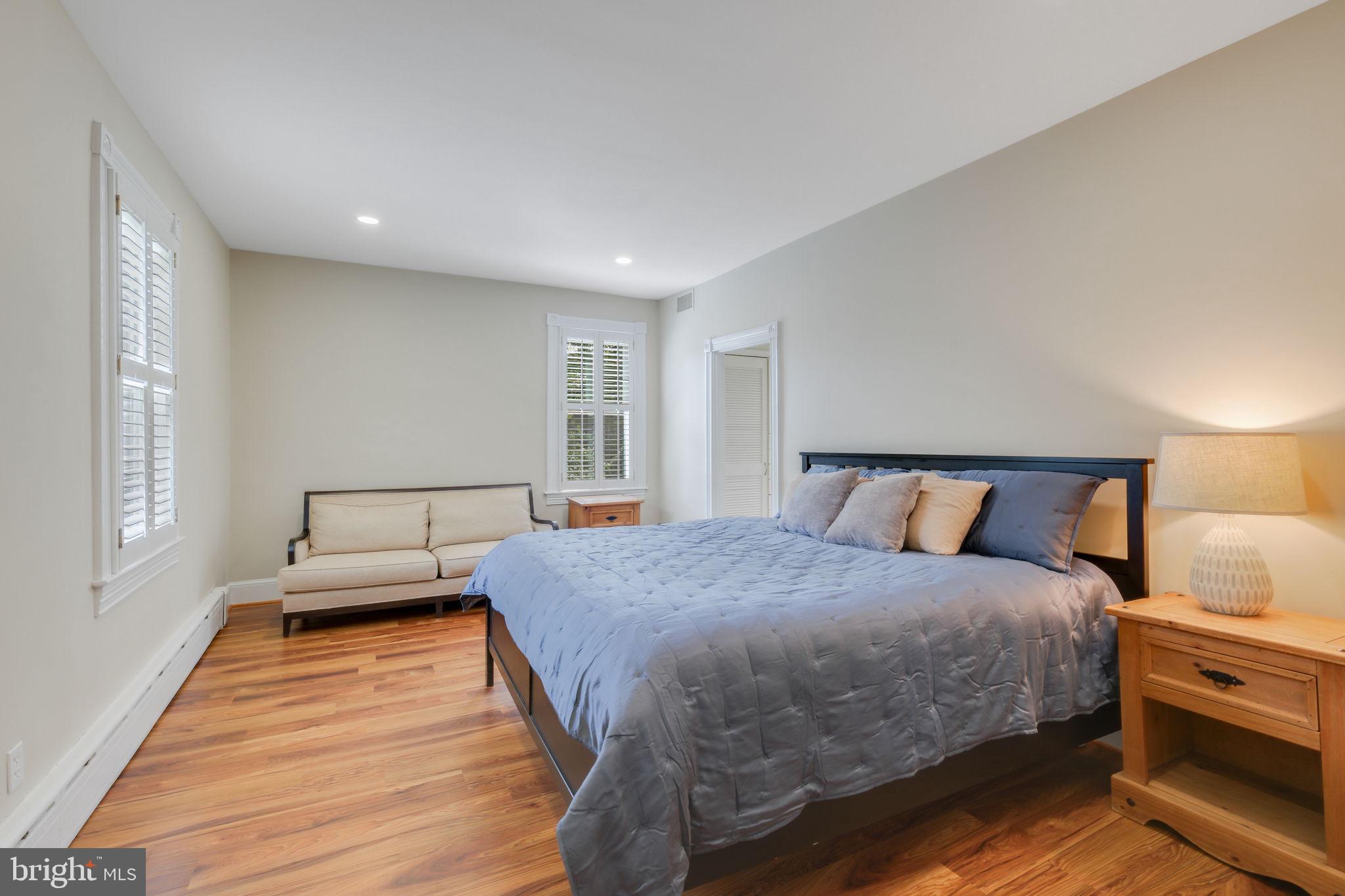 6220 Mazwood Road Rockville, MD 20852 - Photo 21 of 47 a bedroom with a bed and wooden floor