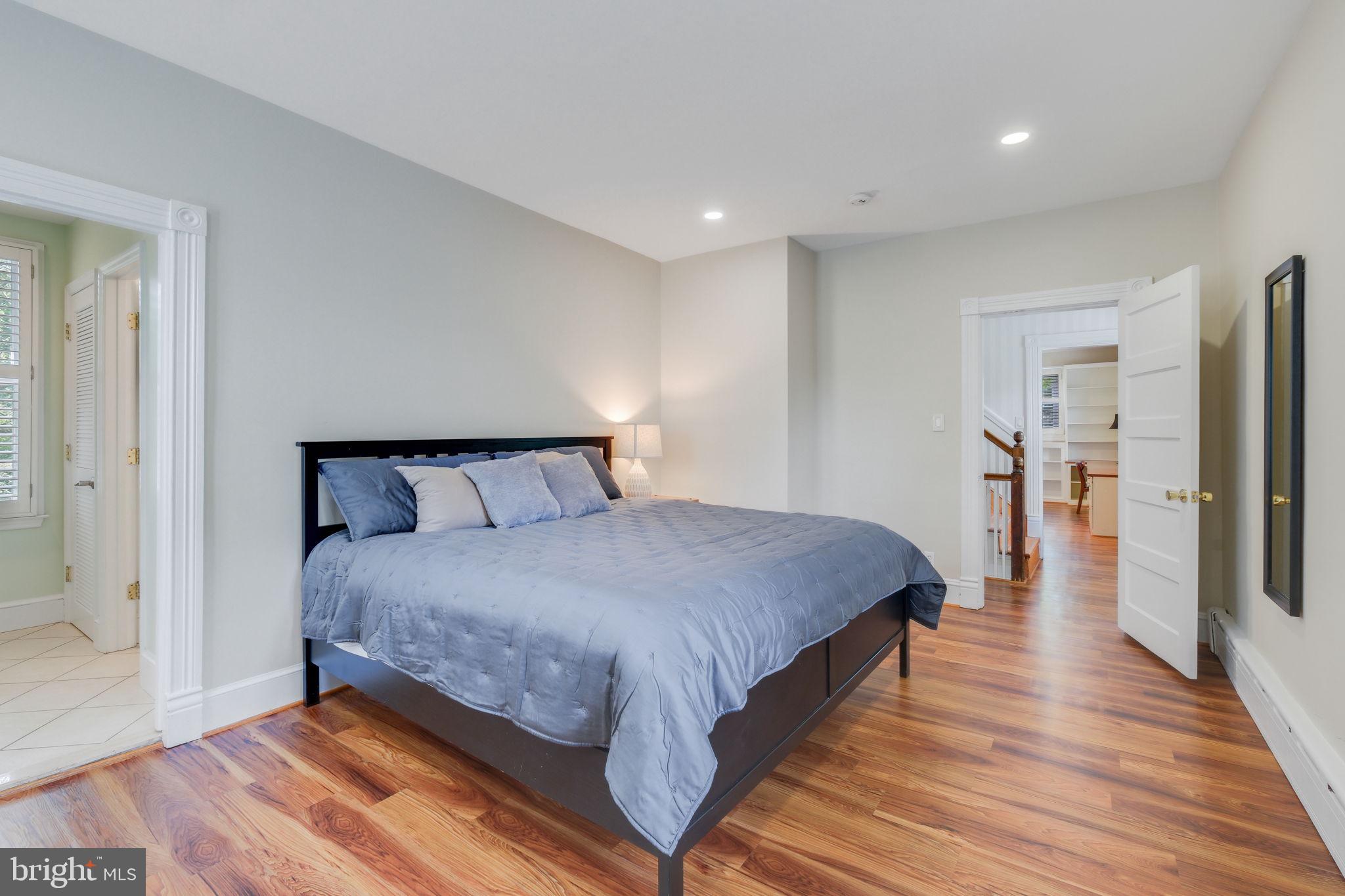 6220 Mazwood Road Rockville, MD 20852 - Photo 22 of 47 a bedroom with bed and wooden floor