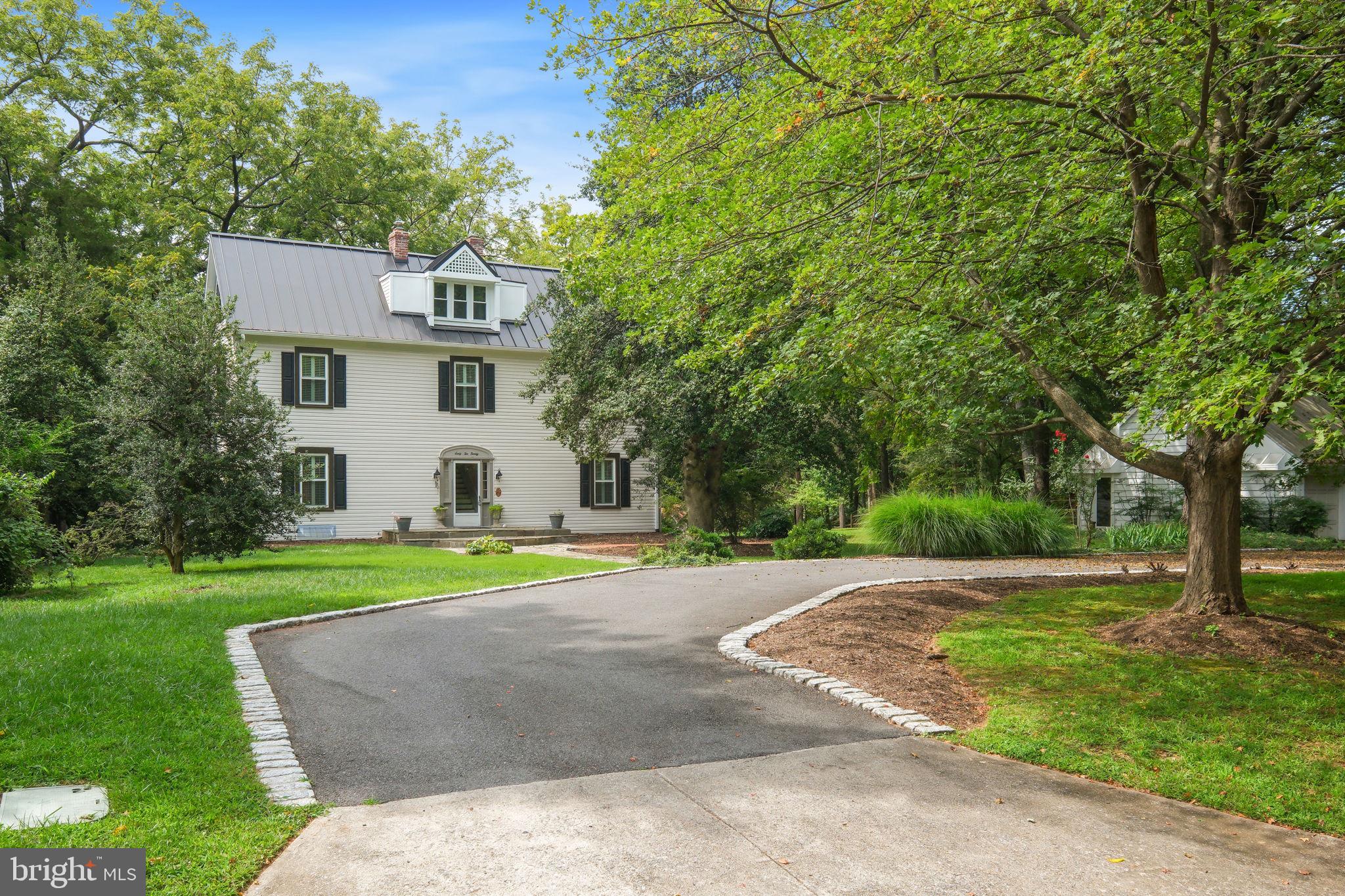 6220 Mazwood Road Rockville, MD 20852 - Photo 3 of 47 a view of a white house in a big yard with large trees