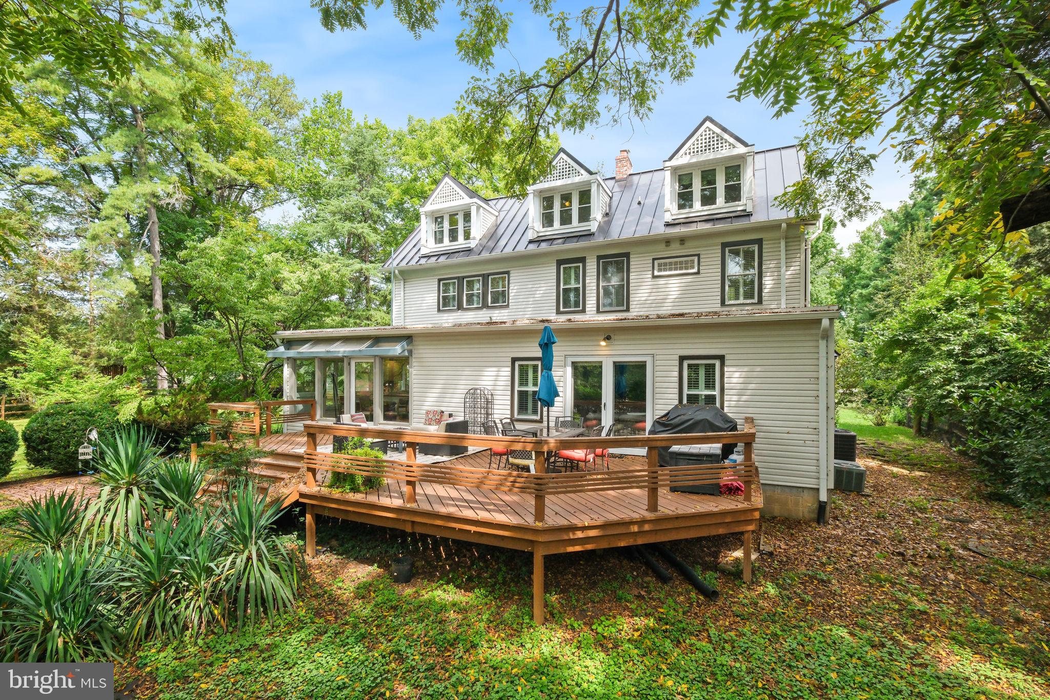 6220 Mazwood Road Rockville, MD 20852 - Photo 35 of 47 a view of a house with a yard and sitting area