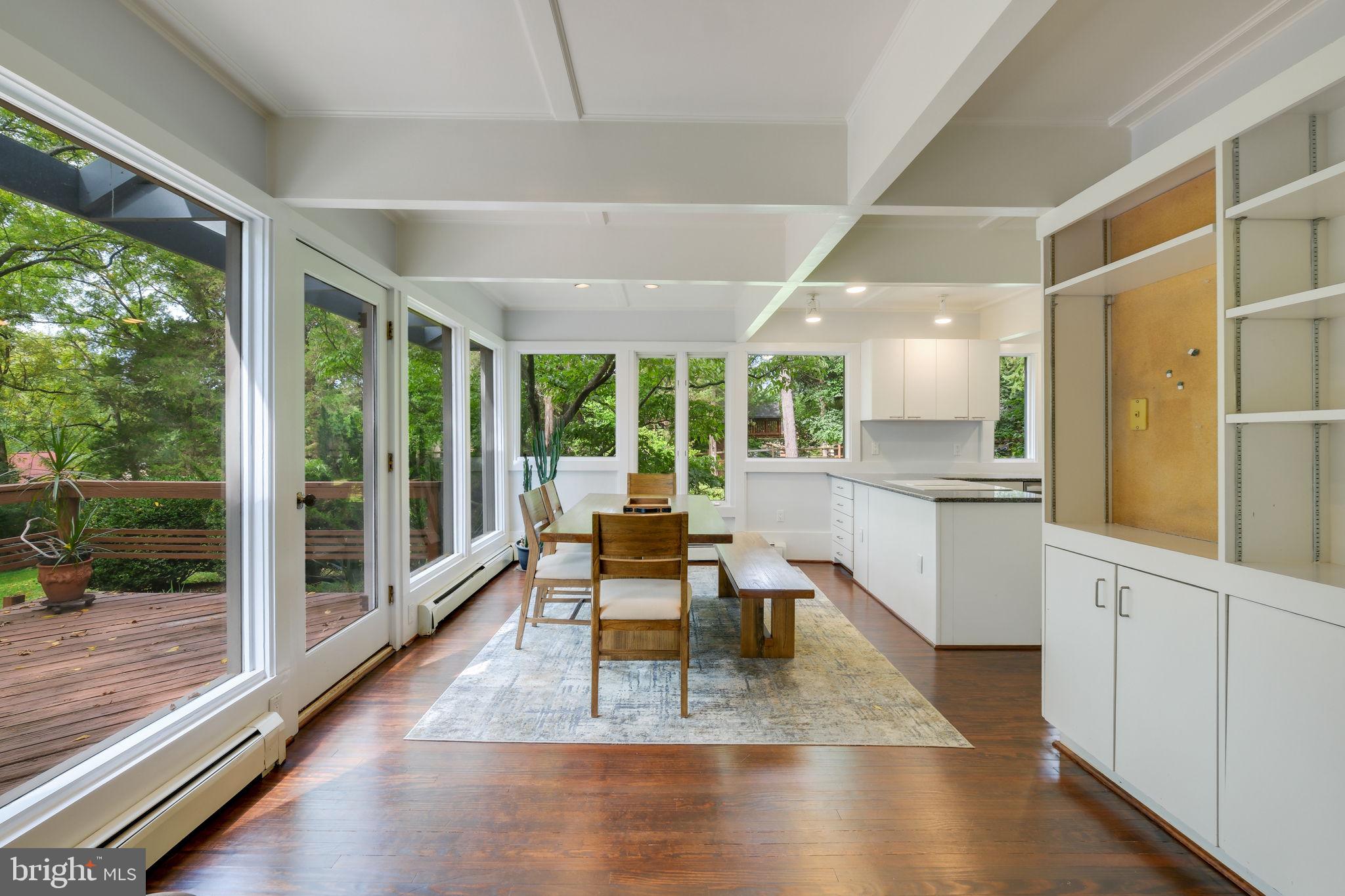 6220 Mazwood Road Rockville, MD 20852 - Photo 10 of 47 a dining room with wooden floor and large windows