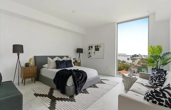 a bedroom with a bed and a couch