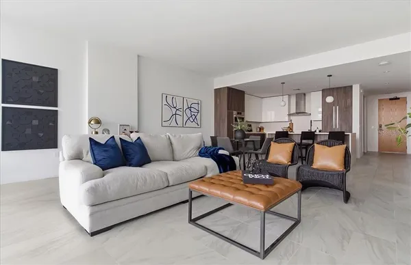 a living room with furniture a rug and a flat screen tv