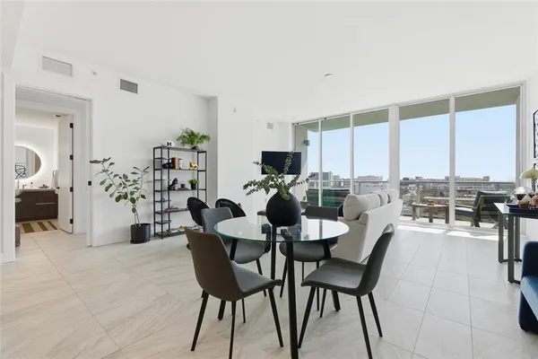 a bedroom with a bed a couch and a potted plant