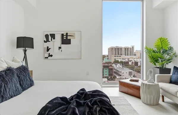 a bedroom with furniture and a potted plant