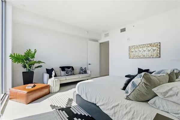 a bedroom with a bed and a couch