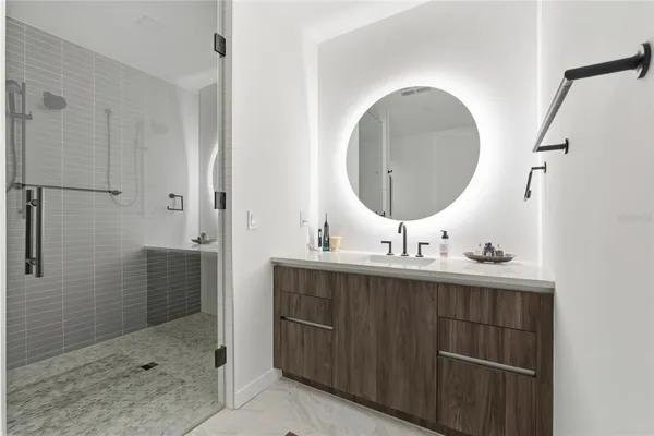 a bathroom with a sink mirror and vanity