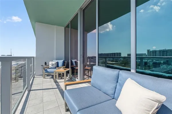a view of an outdoor kitchen and living room