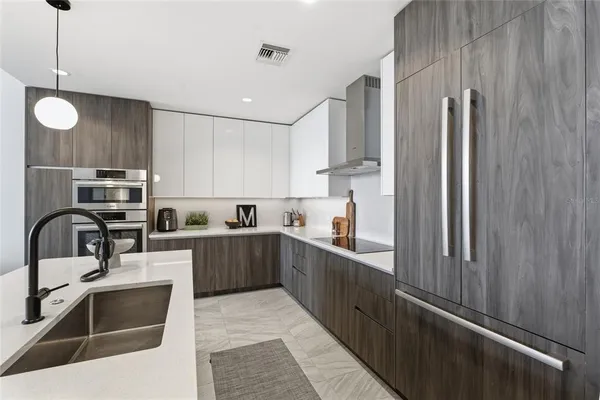a kitchen with stainless steel appliances a refrigerator sink and cabinets