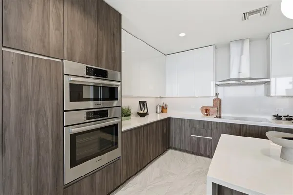 a kitchen with a sink stainless steel appliances and cabinets