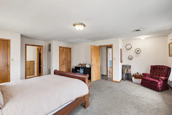 a spacious bedroom with a bed and a couch