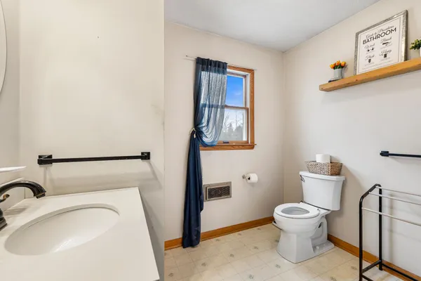 a white toilet sitting next to a bathroom sink