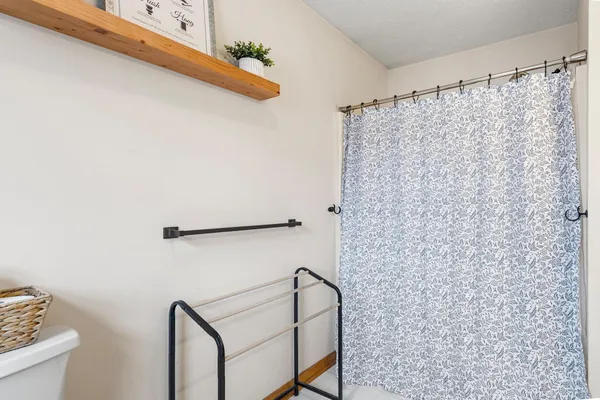a bathroom with a shower curtain and a sink