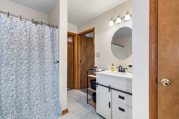 a bathroom with a sink a vanity and a mirror
