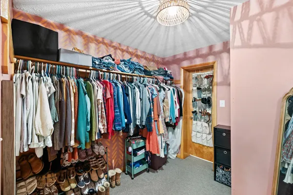 a view of walk in closet with clothes