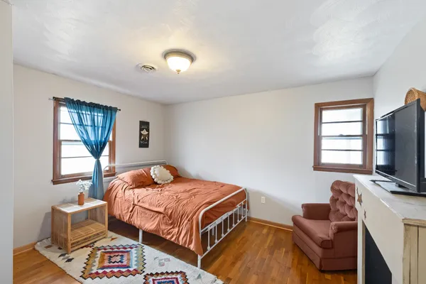 a bedroom with a bed and flat screen tv