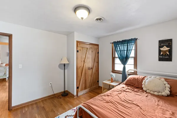 a bedroom with a bed and a window