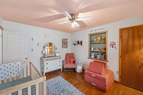 a bedroom with furniture and wooden floor
