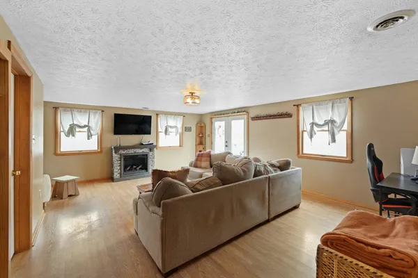 a living room with furniture and a wooden floor