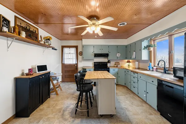 a kitchen with cabinets a sink and appliances