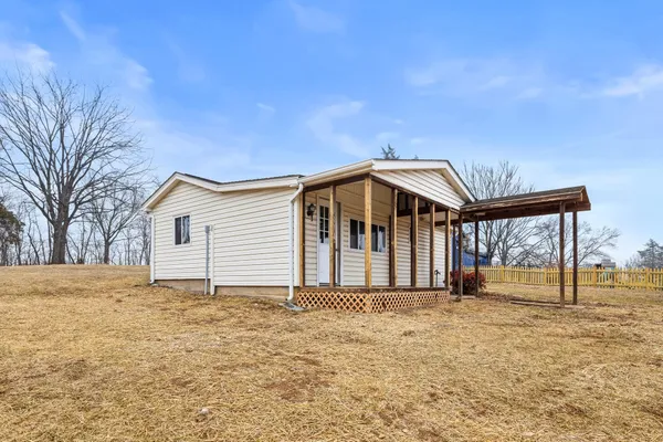 a kitchen with stainless steel appliances granite countertop a sink cabinets and wooden floor