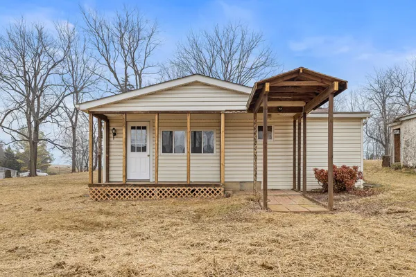 a kitchen with granite countertop cabinets stainless steel appliances a sink and a window